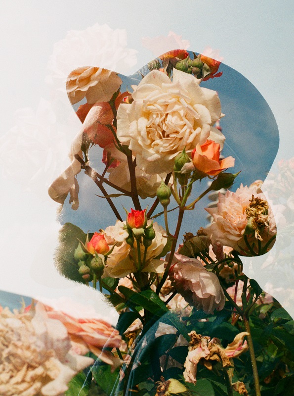 analogue double exposure portrait of a man wearing a hat